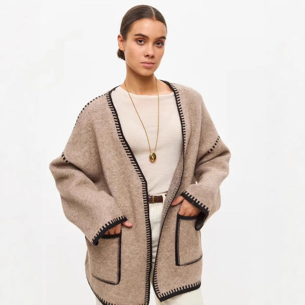 Loose black lace-up knitted cardigan sweater coat with long sleeves.