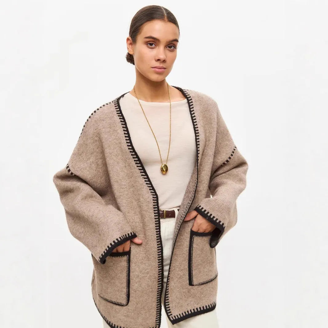 Loose black lace-up knitted cardigan sweater coat with long sleeves.