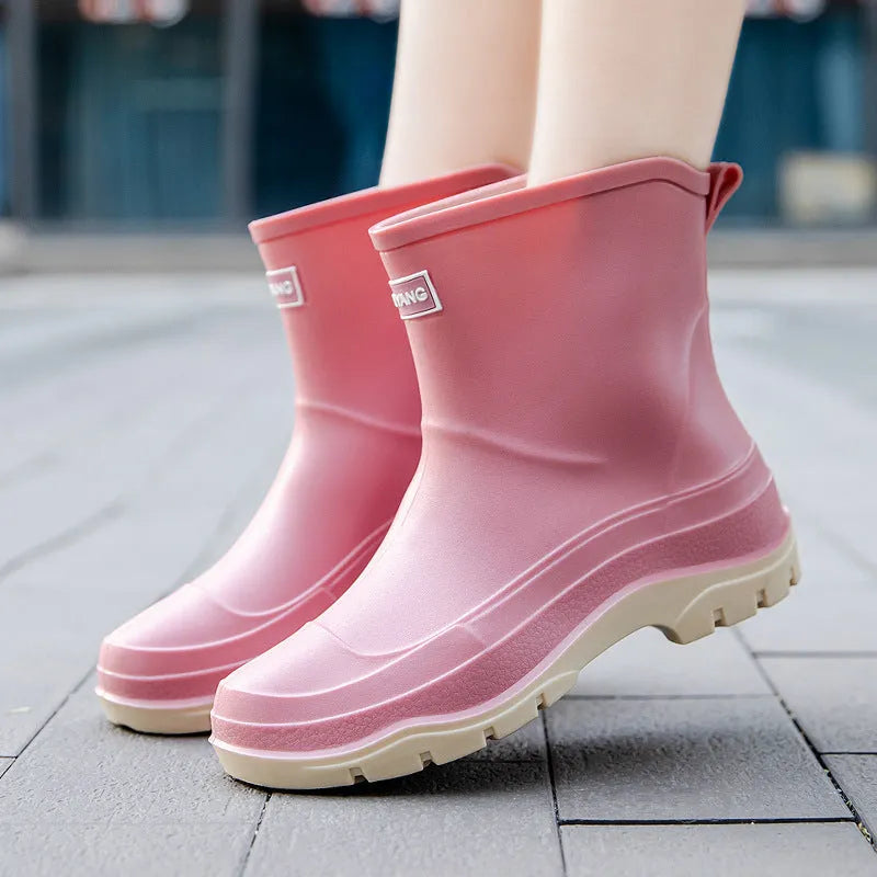 Women's short plastic waterproof rubber shoes in black, shown on a white background.