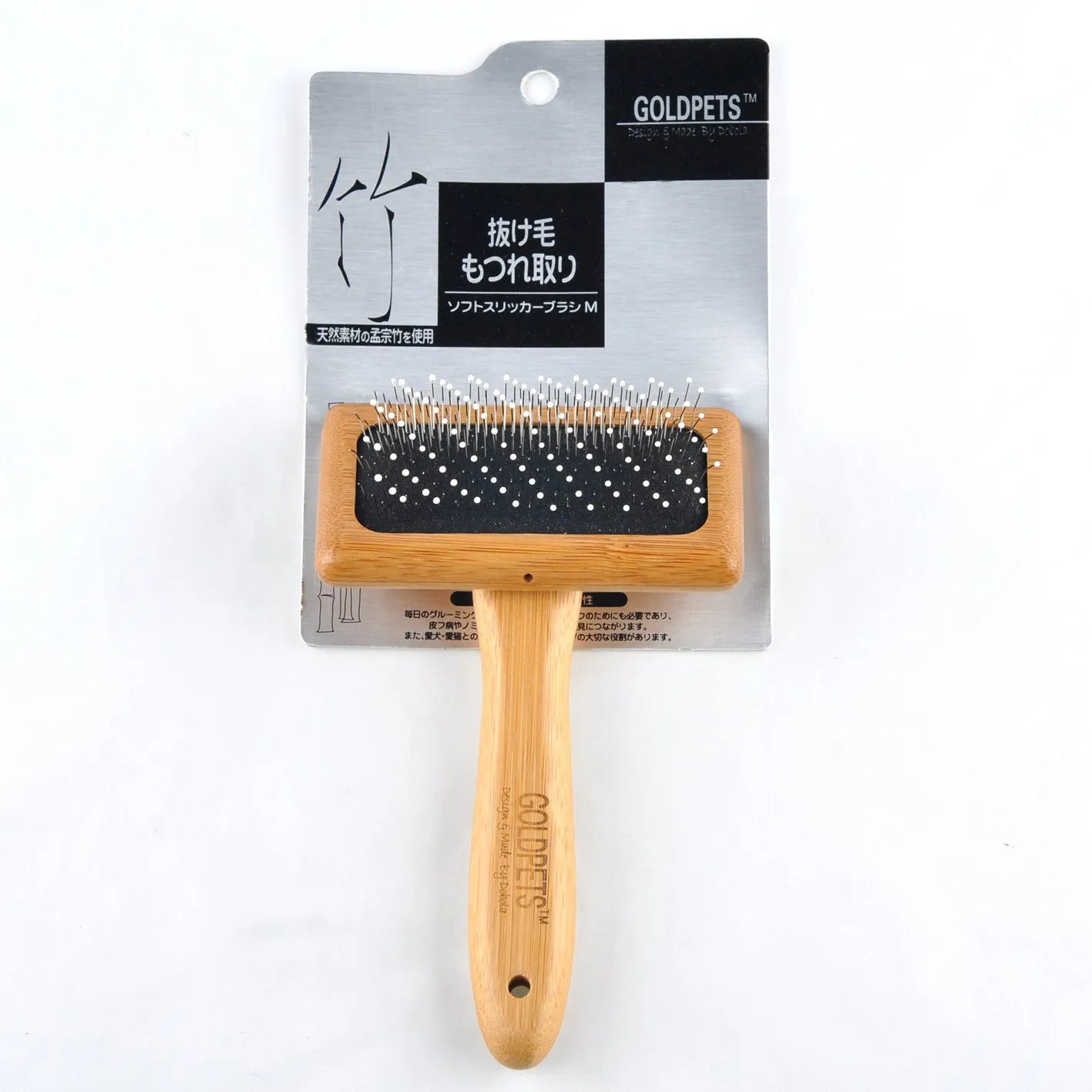 Pet grooming bamboo wood air cushion needle comb with original bamboo colour handle and steel pins on a clean background