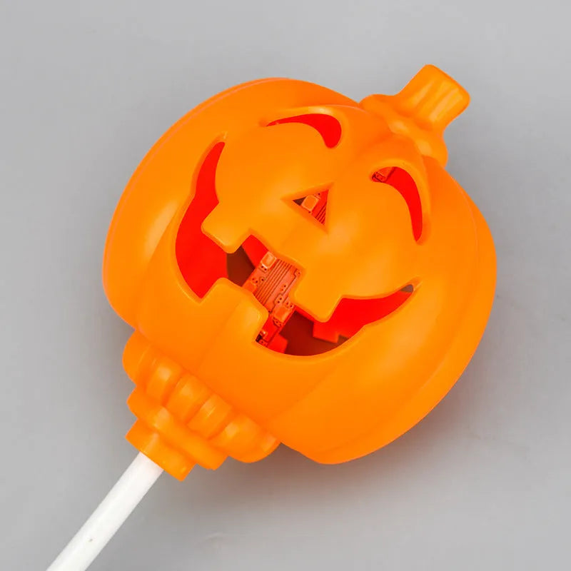 Plastic pumpkin-shaped lamp glowing with either purple or yellow light, measuring 22cm tall.