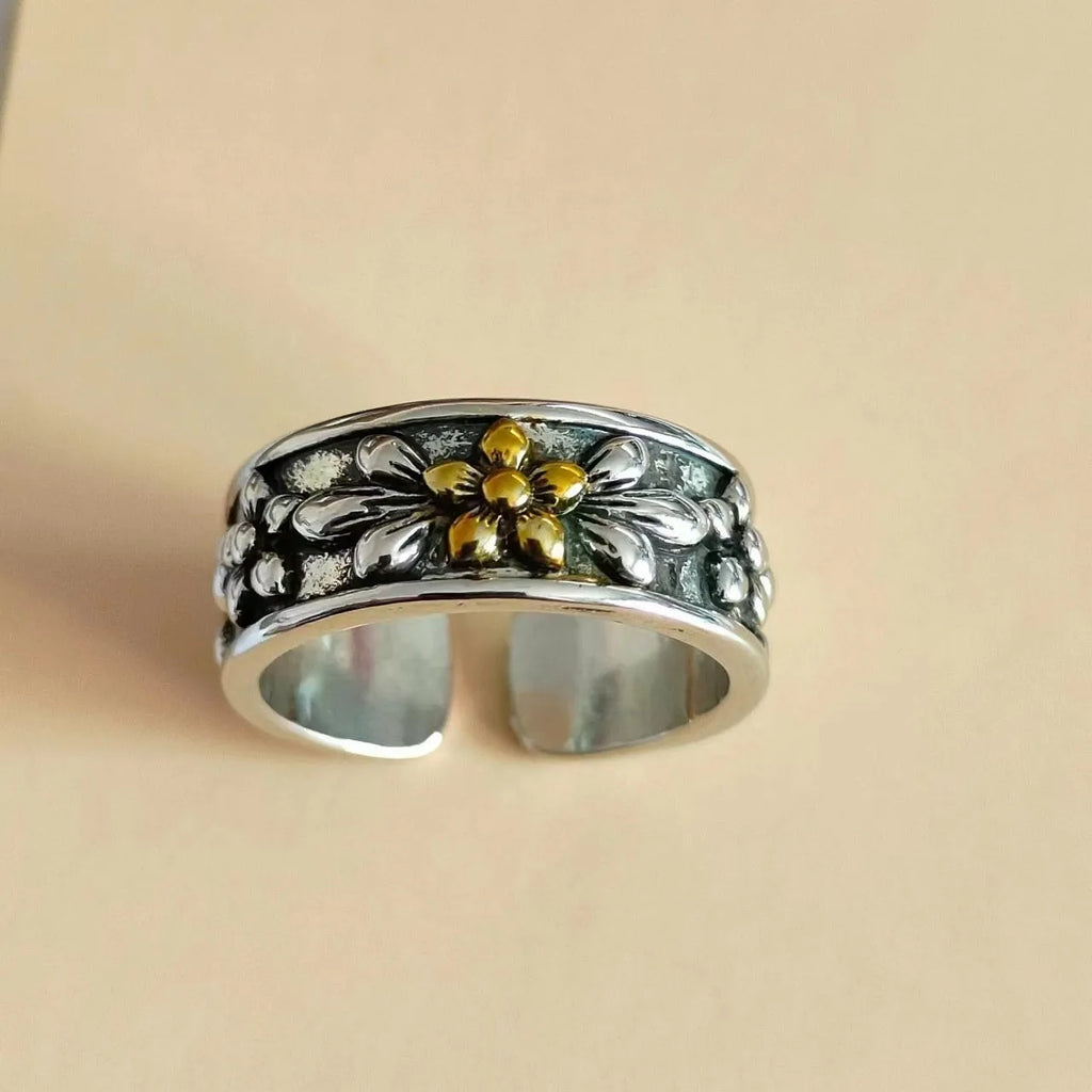 Vintage antique silver gold flower open ring with adjustable band and floral camellia motif on light background