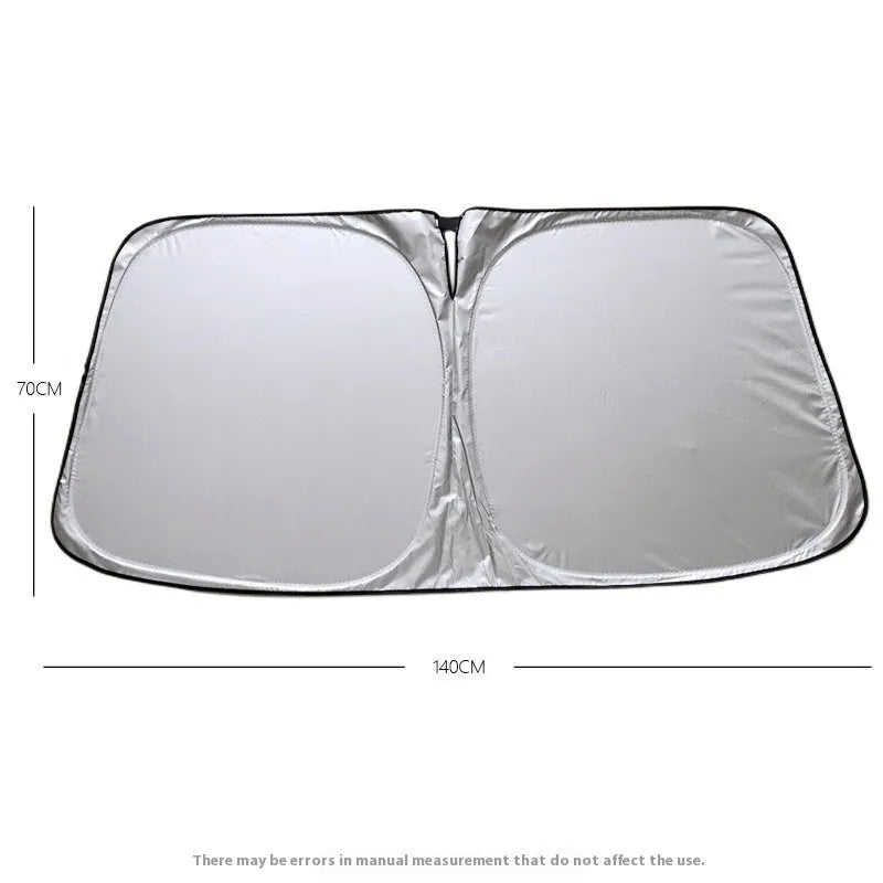 Titanium silver aluminium foil car windscreen sunshade unfolded on a dashboard.