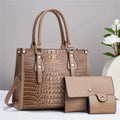 Women's three-piece luggage set showing crossbody bag, wallet, and card holder in contrasting colour with minimalist texture