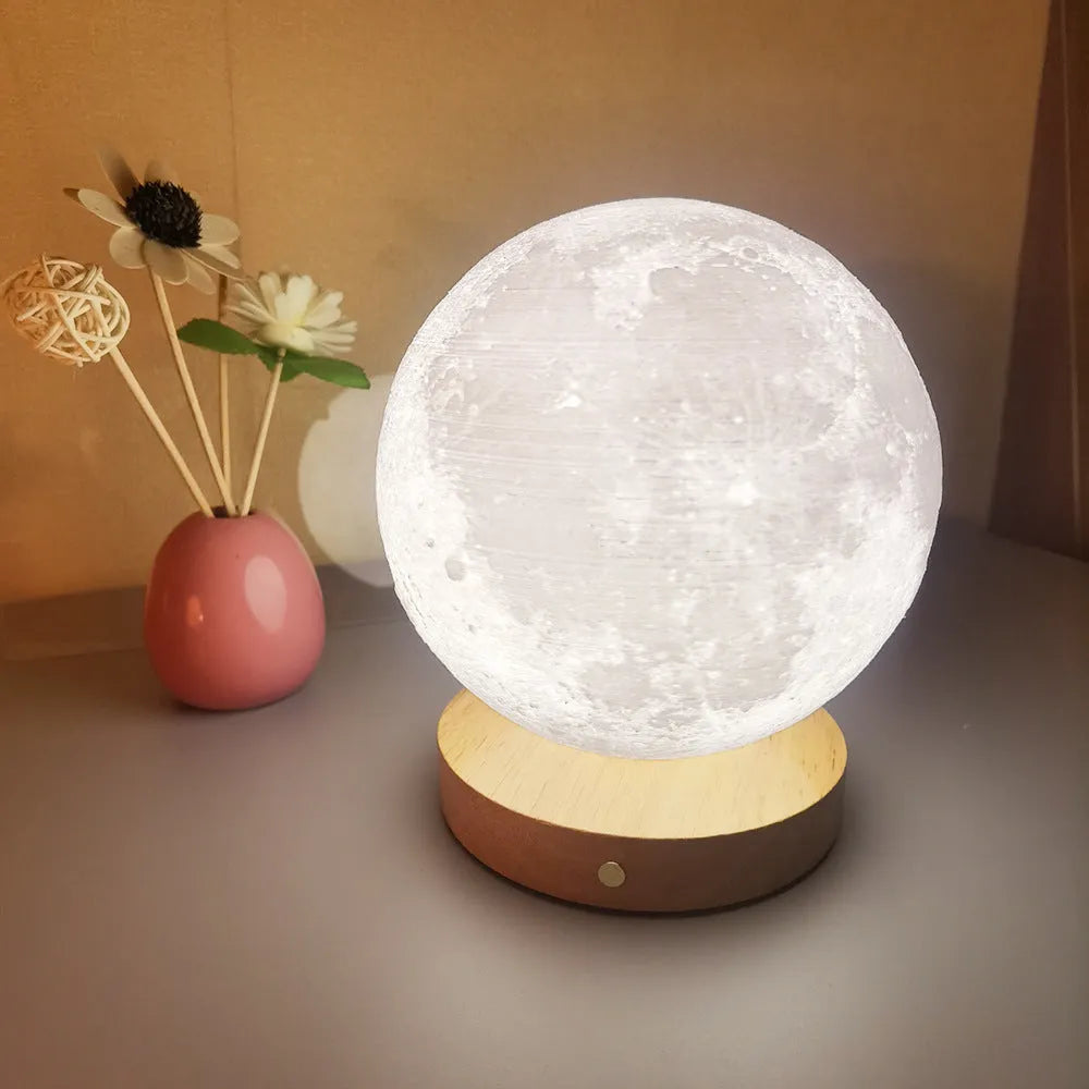 Rotating three-colour moon night light on a wooden base, showing 12cm, 15cm, and 18cm size options.