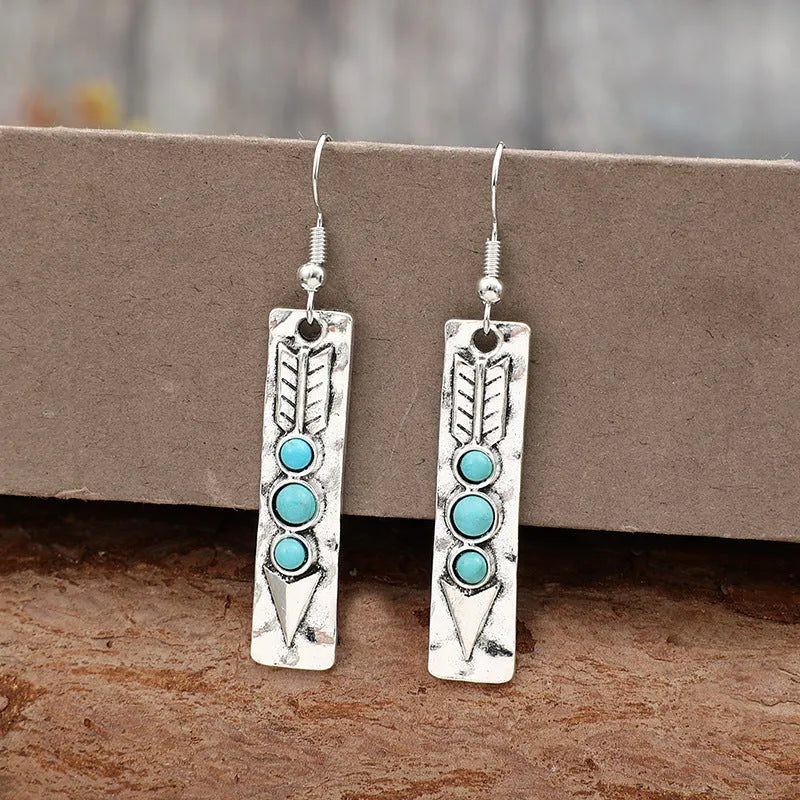 Silver geometric earrings with turquoise inlay in long strip design