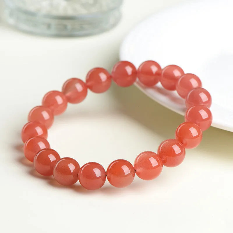 Natural South Cherry Red Agate bracelet with polished beads on an elasticated cord.