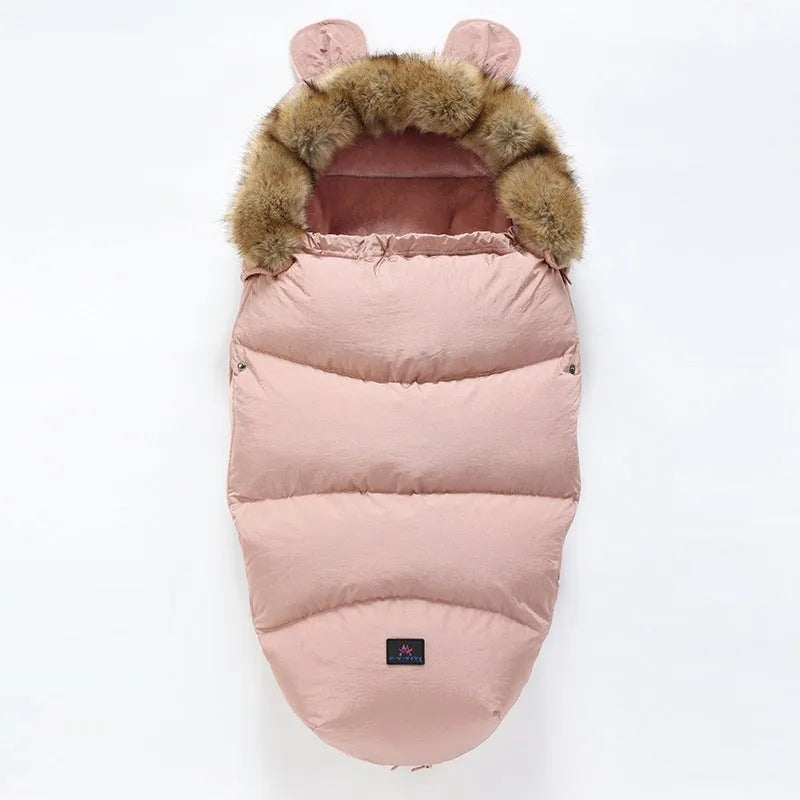 Convertible baby sleeping bag cocoon in a pram, showing cotton blend fabric and flannel lining.