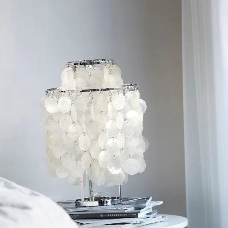 Shell-shaped bedside table lamp in chrome finish measuring 30cm diameter by 46cm tall