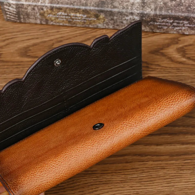 Vintage brown floral embossed women's tri-fold leather wallet showing interior organisation