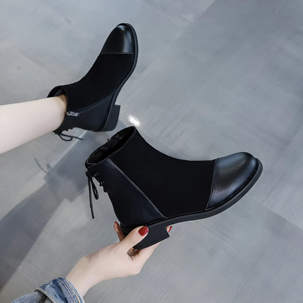 Black women's knee-high Martin boots with side zipper, round toe, and decorative bow.