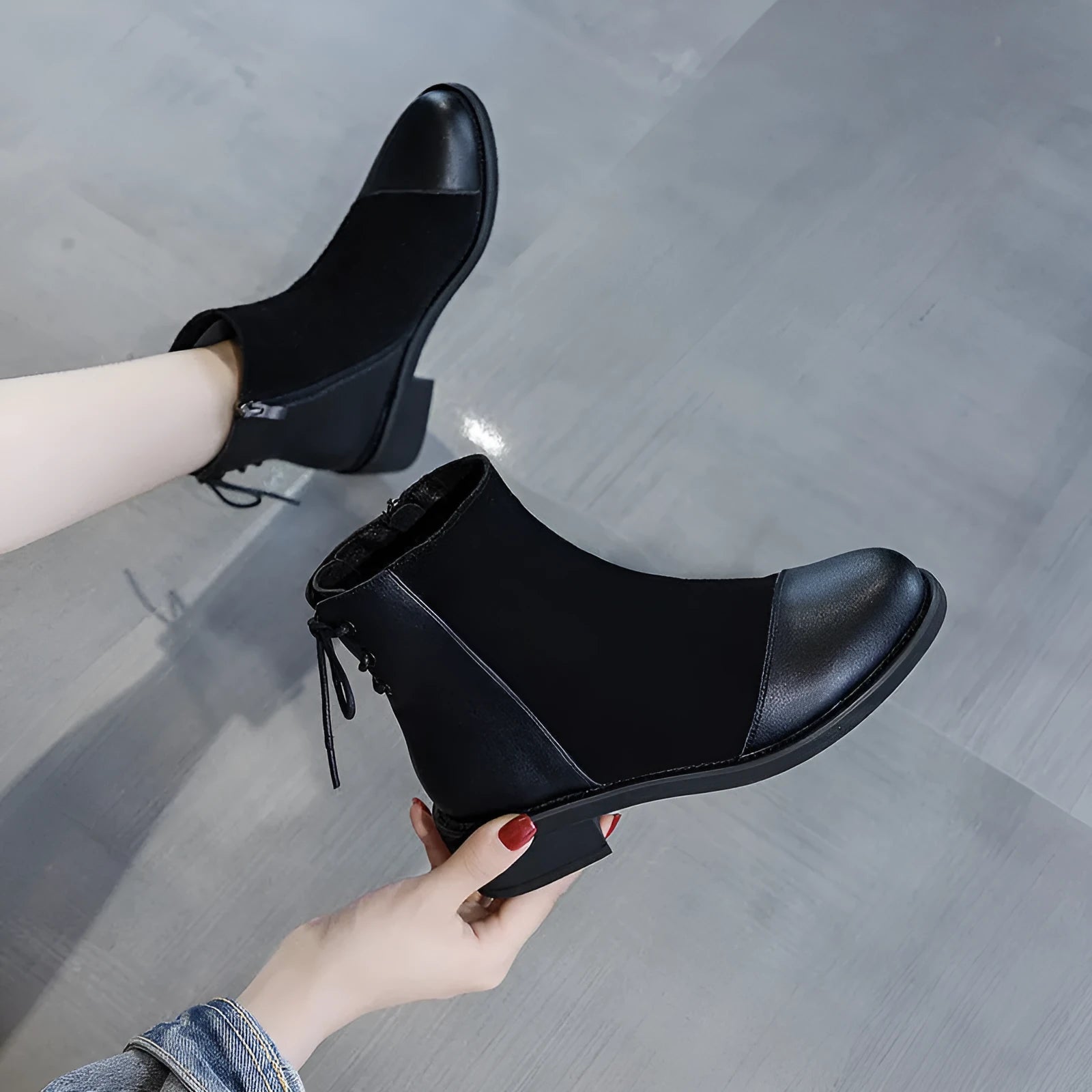 Black women's knee-high Martin boots with side zipper, round toe, and decorative bow.