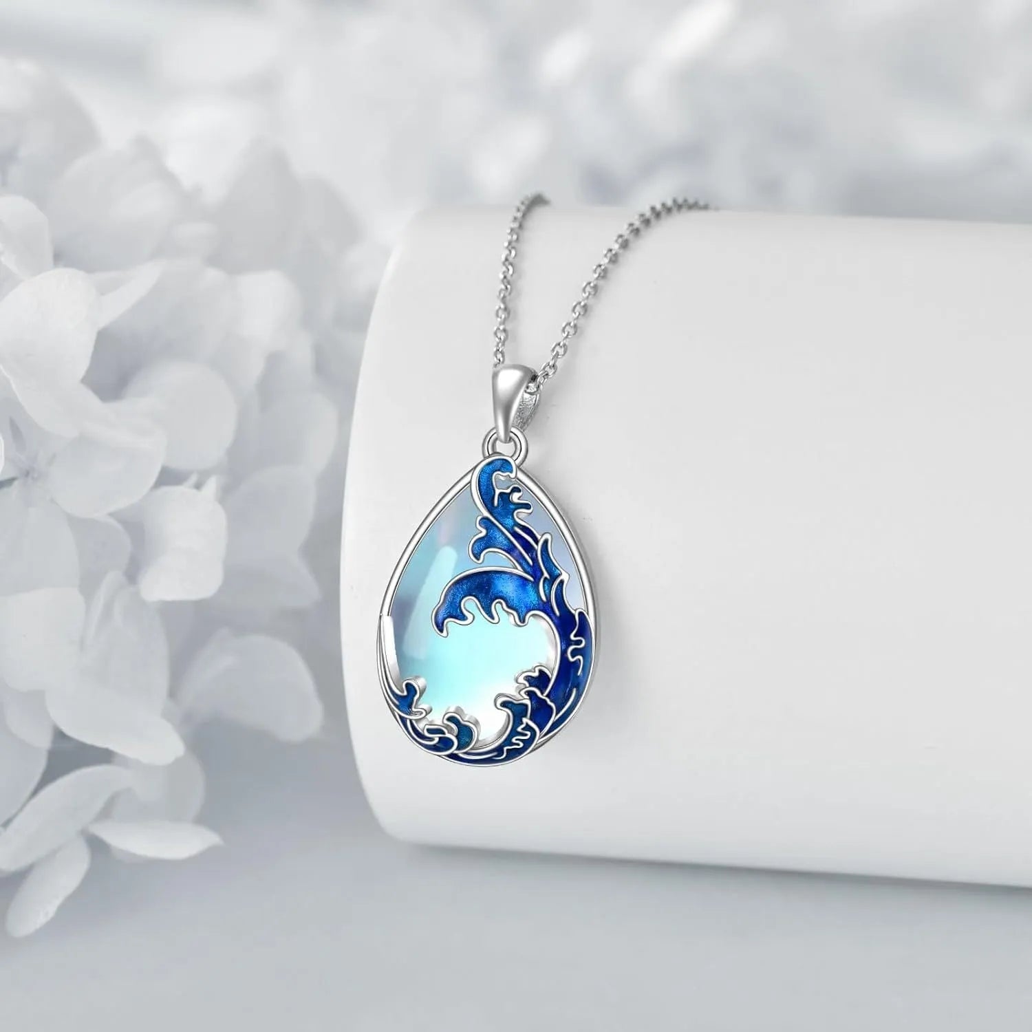Close-up of a moonstone blue heart-shaped alloy pendant on a women's necklace.