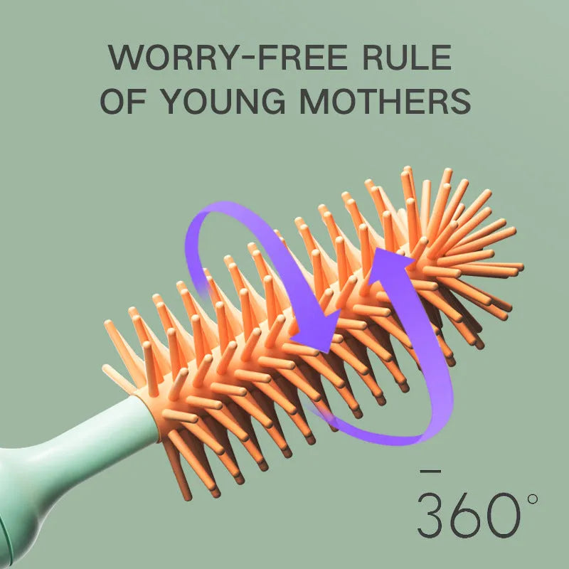 Pink and green electric baby bottle cleaning brush with rotating silicone head on a table