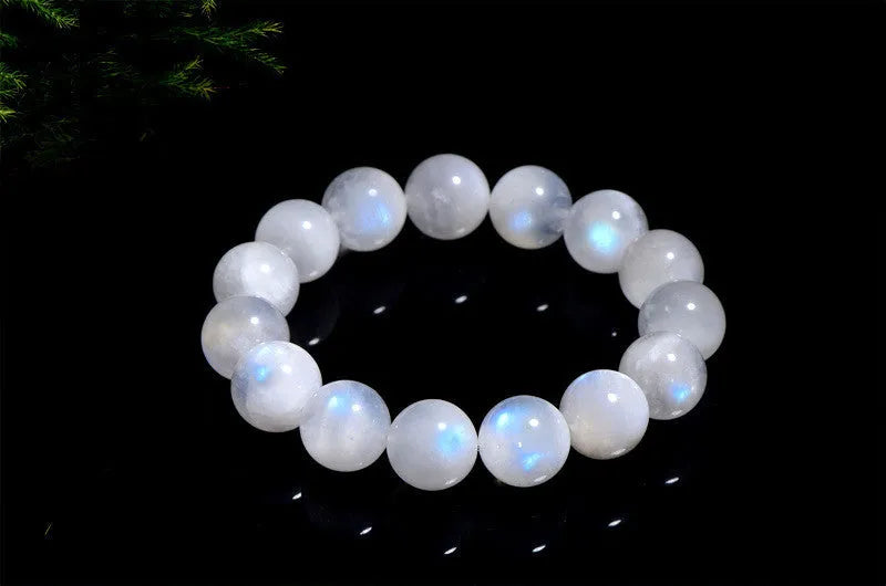 Natural blue moonlight coloured moonstone round bead bracelet on a white background.