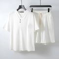 Loose linen style men's two-piece set with short sleeve top and shorts in cotton fabric.