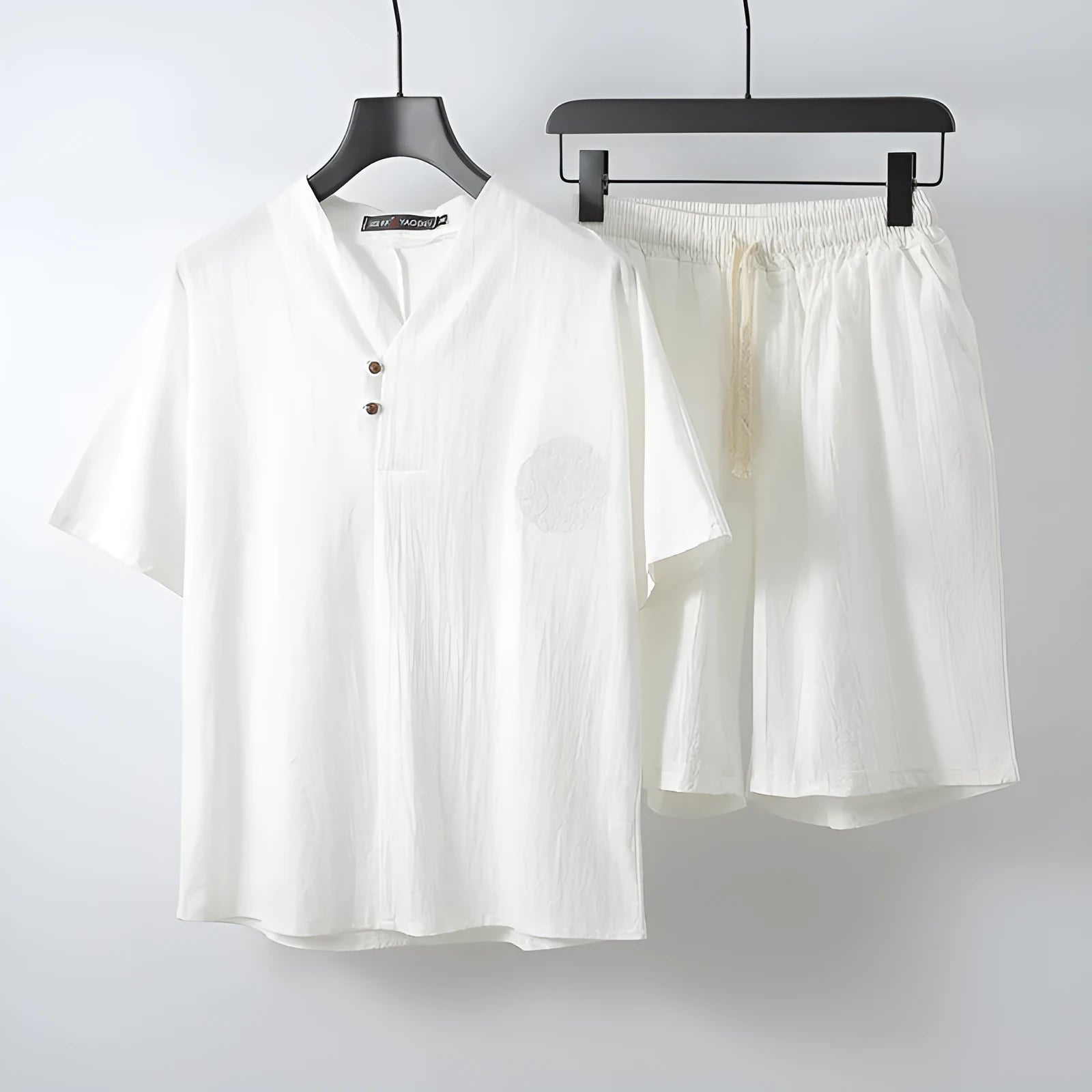 Loose linen style men's two-piece set with short sleeve top and shorts in cotton fabric.