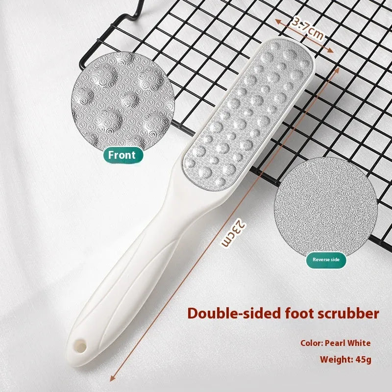 Double-sided stainless steel foot grinder with white and black sandpaper surfaces for callus removal