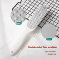 Double-sided stainless steel foot grinder with white and black sandpaper surfaces for callus removal
