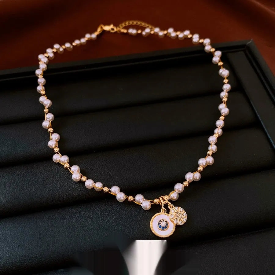 Gold electroplated zircon and imitation pearl pendant necklace on adjustable clavicle chain