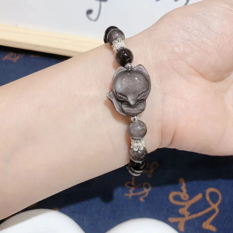 Natural silver stone big head fox bracelet with 8mm obsidian beads on a white background