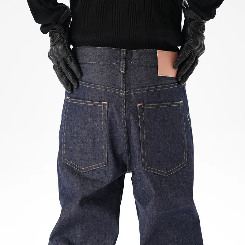 Man's dark blue loose-fit straight leg denim jeans on a neutral background.