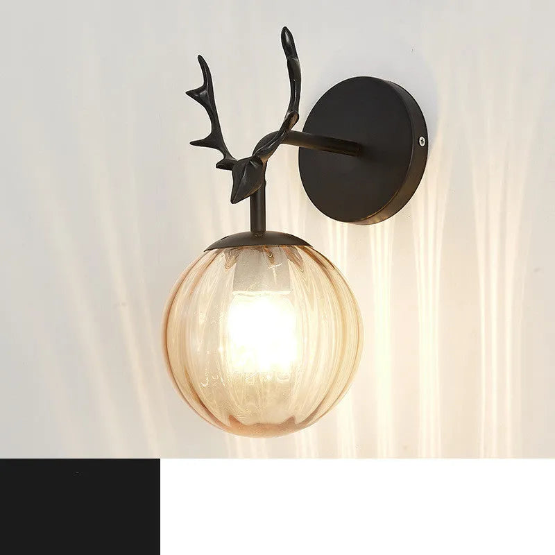 Round glass Nordic wall lamp with golden water pattern finish on a white wall.