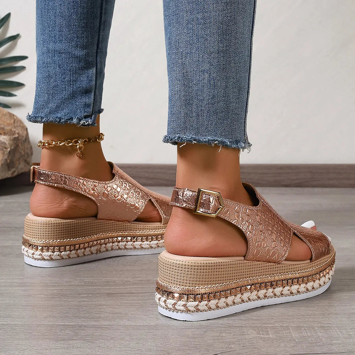 Gold Roman sandals with round toe, hollow-out design, and ankle buckle on rubber sole