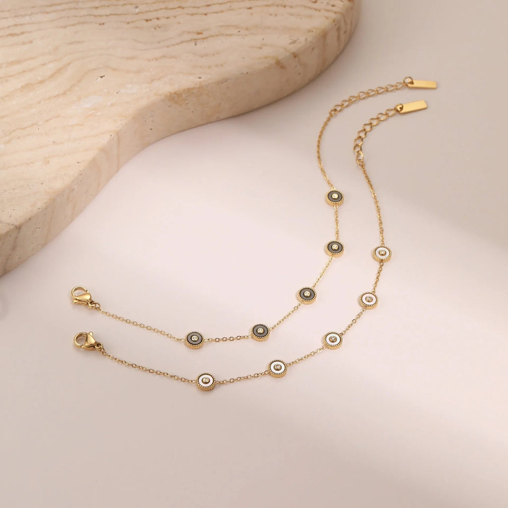 Women's stainless steel bracelet with 18K gold plating and geometric fritillary charm, includes matching necklace