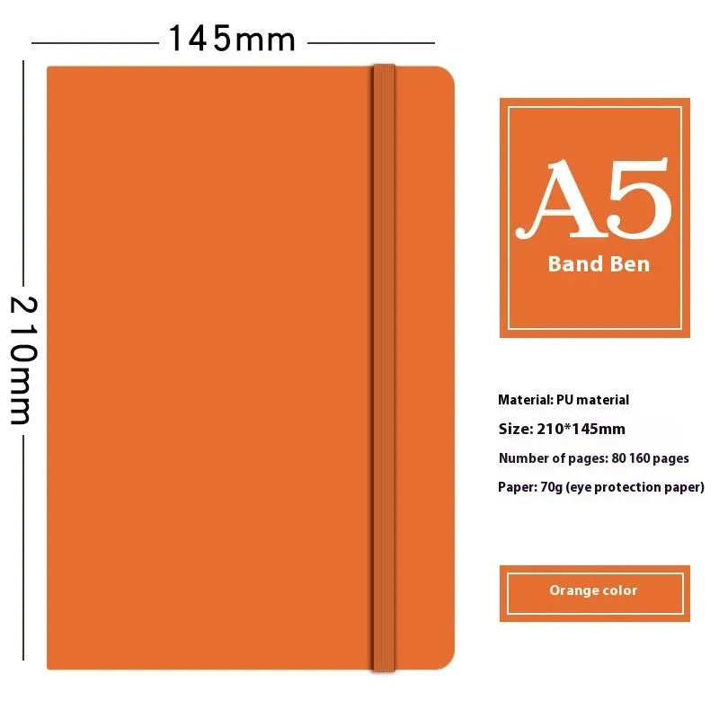 A5 faux leather notebook with pen insert and strap, open on a desk showing lined pages