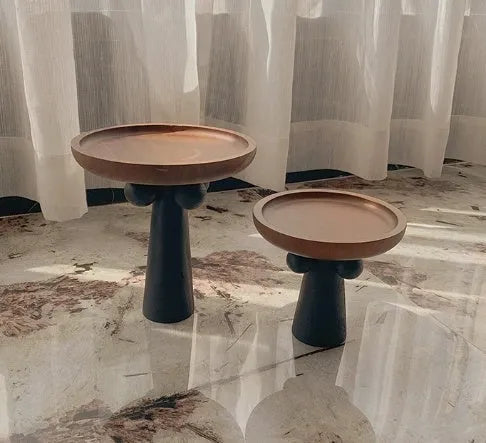 High-legged round wooden tray in a modern Nordic style for candle and decor display.