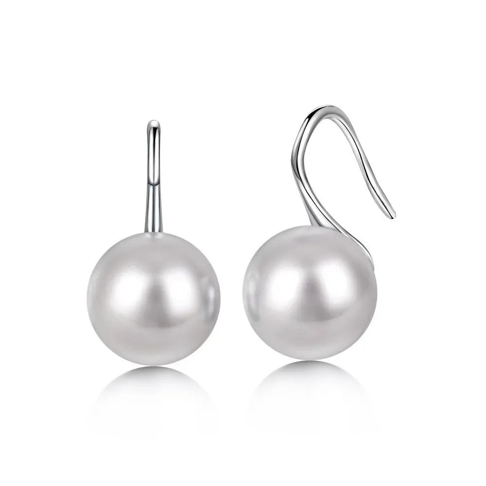 Silver round stud earrings with 12mm white shell pearl inlay on simple background