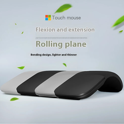 Black folding Bluetooth wireless mouse shown both folded and unfolded beside laptop