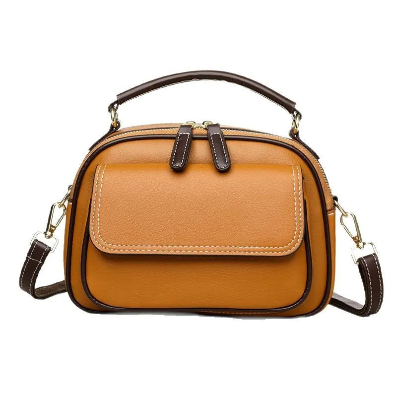 Black women's cross-body PU shoulder bag with adjustable straps showing its square shape and size.