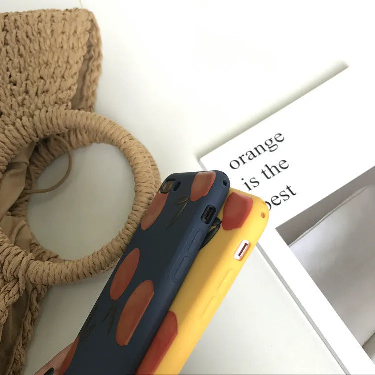 Orange matte finish TPU silicone case for iPhone on a table.