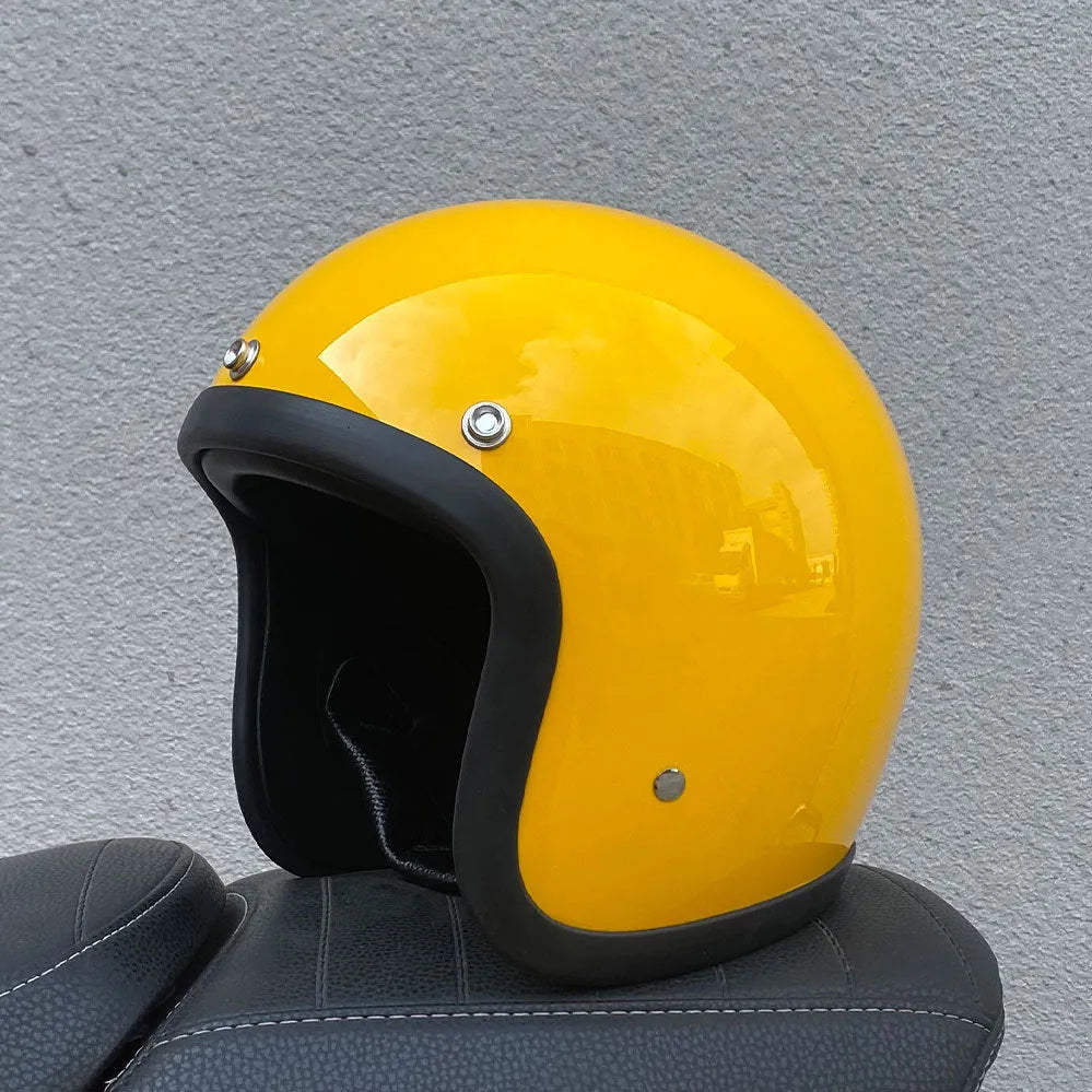 A retro-style grey half helmet for motorcycle riding, shown on a stand.