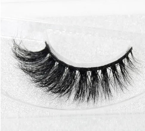 Pair of faux mink eyelashes with long tail and cotton stem against white background