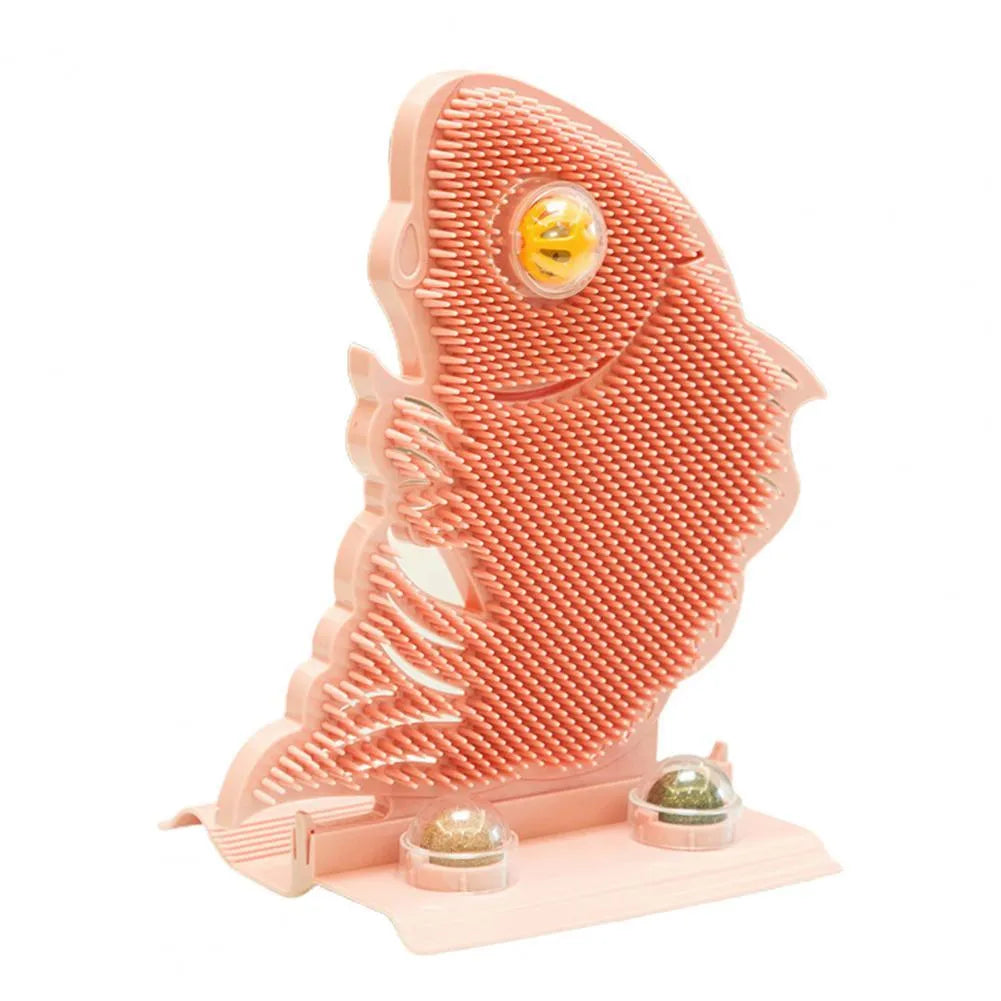Blue plastic fish-shaped cat wall scratcher with brush, two green catnip balls, a bell, and a mounting base.