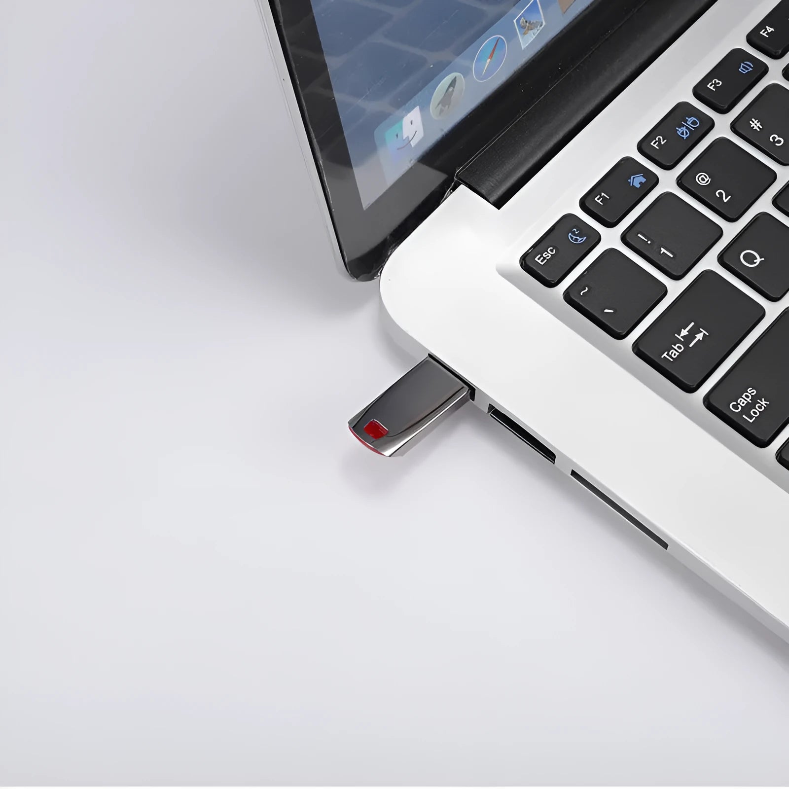 Silver metal USB flash drive on a white background showing its USB connector.