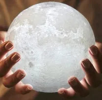 3D printed white moon lamp on wooden stand with touch-sensitive metal ring at base.