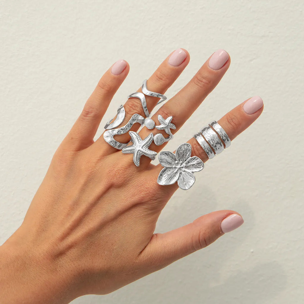 Women's irregular ocean shell ring set with starfish and fan shapes, light gold electroplated metal, 4-piece arrangement