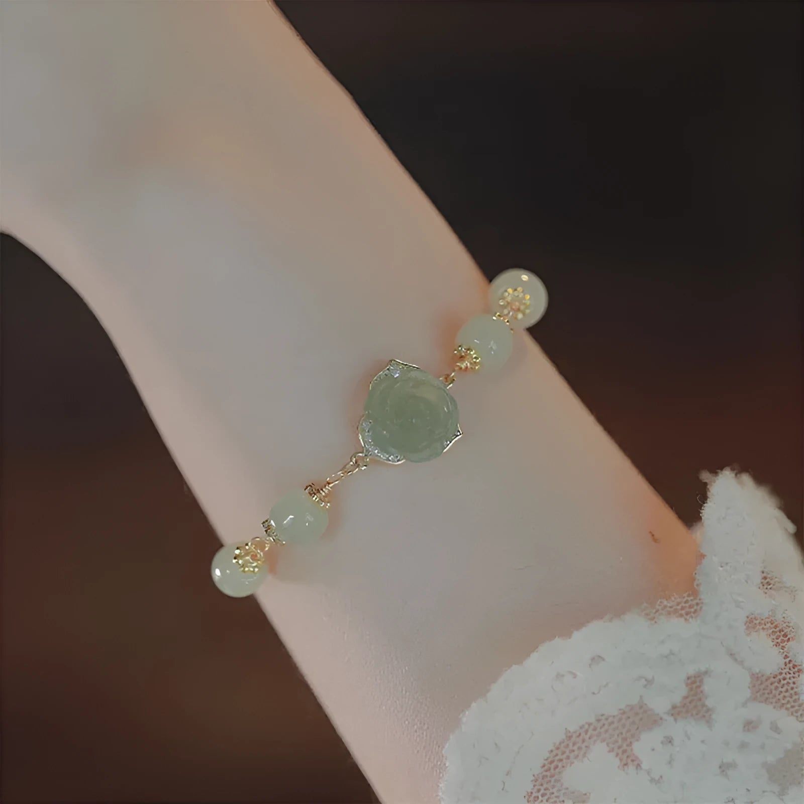 Handmade women's bracelet with rose-coloured Hetian Jade and 14K gold-plated finish in a floral design.