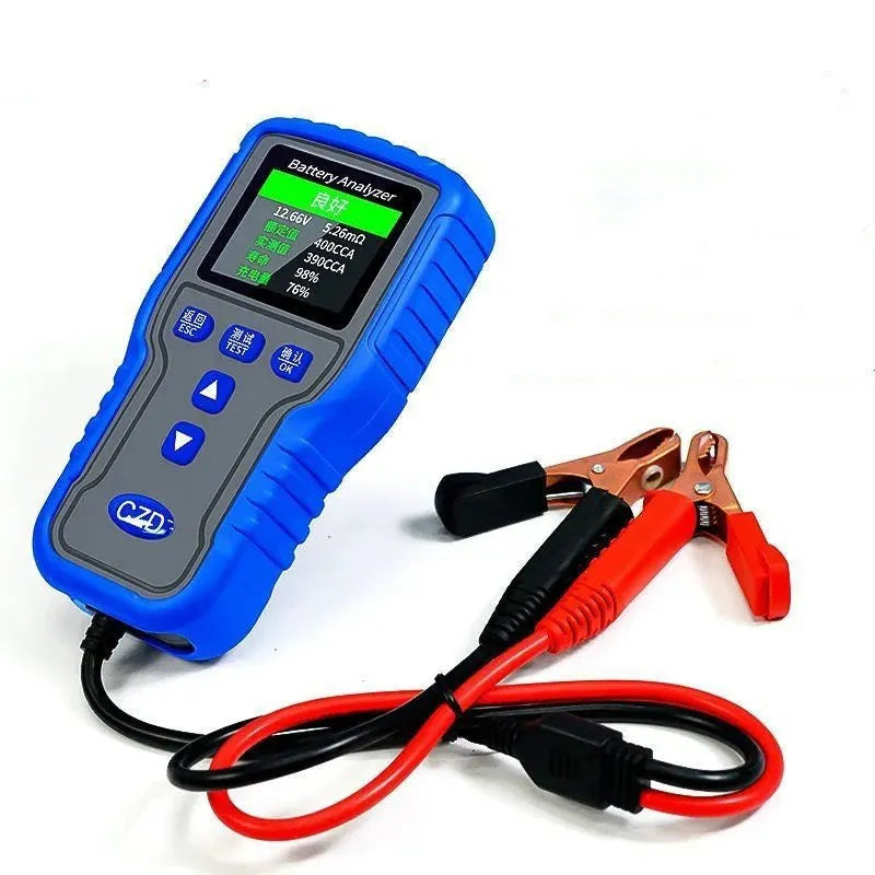 TKM016 car battery tester on a workbench, showing its compact 167x86x32mm size and handheld design