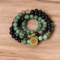 Green and black elastic beaded alloy bracelet on a wrist, showing its natural style and length.