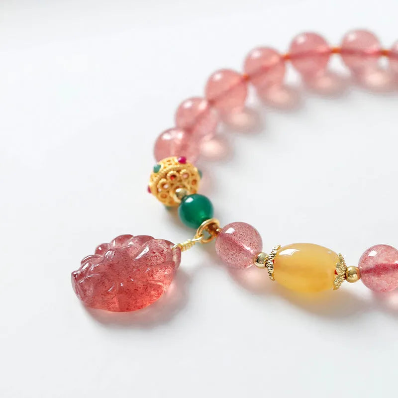 Women's Nine Tail Fox design bracelet with polished strawberry quartz crystal beads.