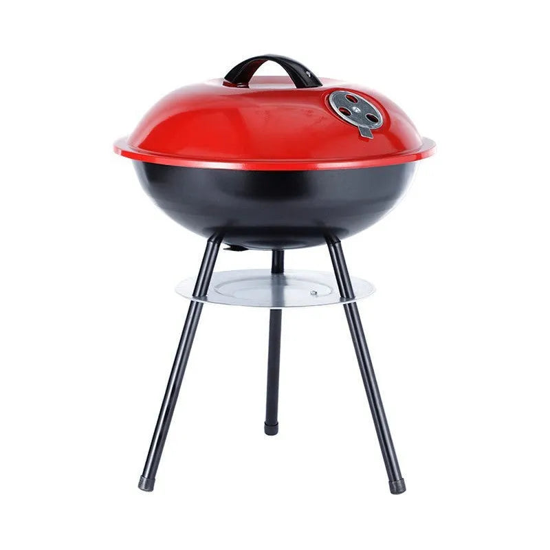 A portable cast iron barbecue oven with a 14-inch cooking surface, shown outdoors.