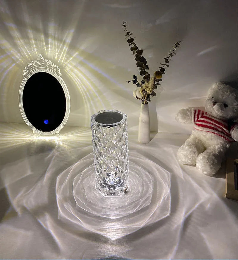 Modern acrylic rose LED table lamp with diamond base and touch control on wooden surface