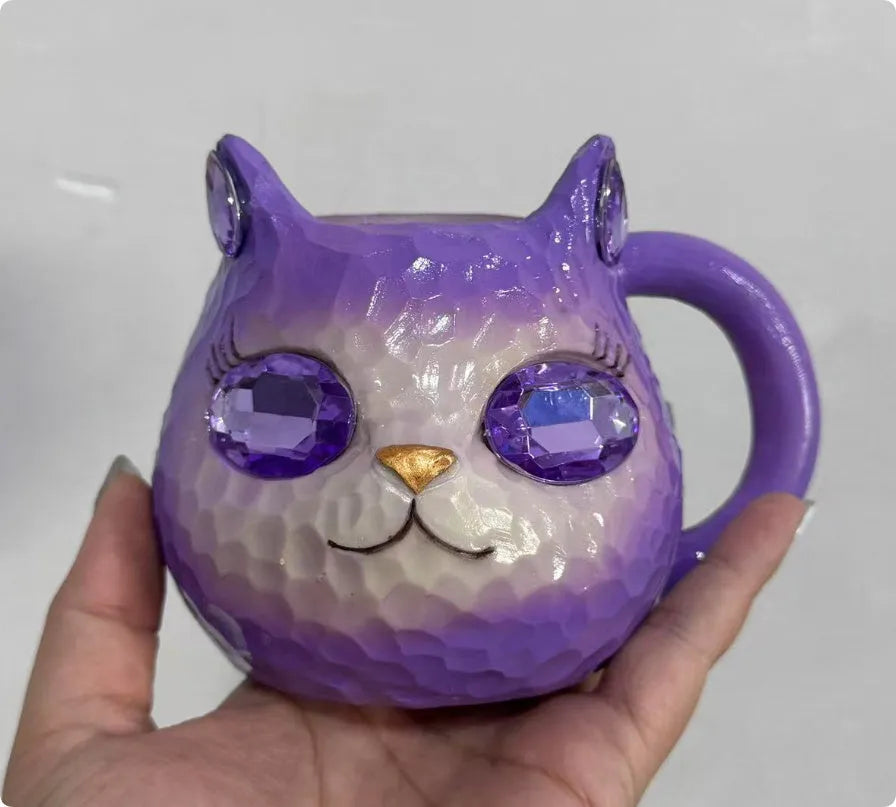 Resin cat cup crystal globe decorative ornament on a desk, shown in purple colour.