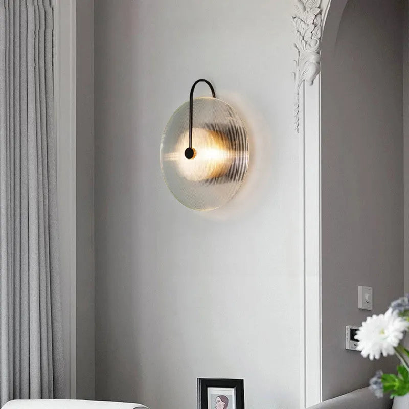Round glass wall lamp in gold finish with glass shade and iron body for bedside or aisle lighting