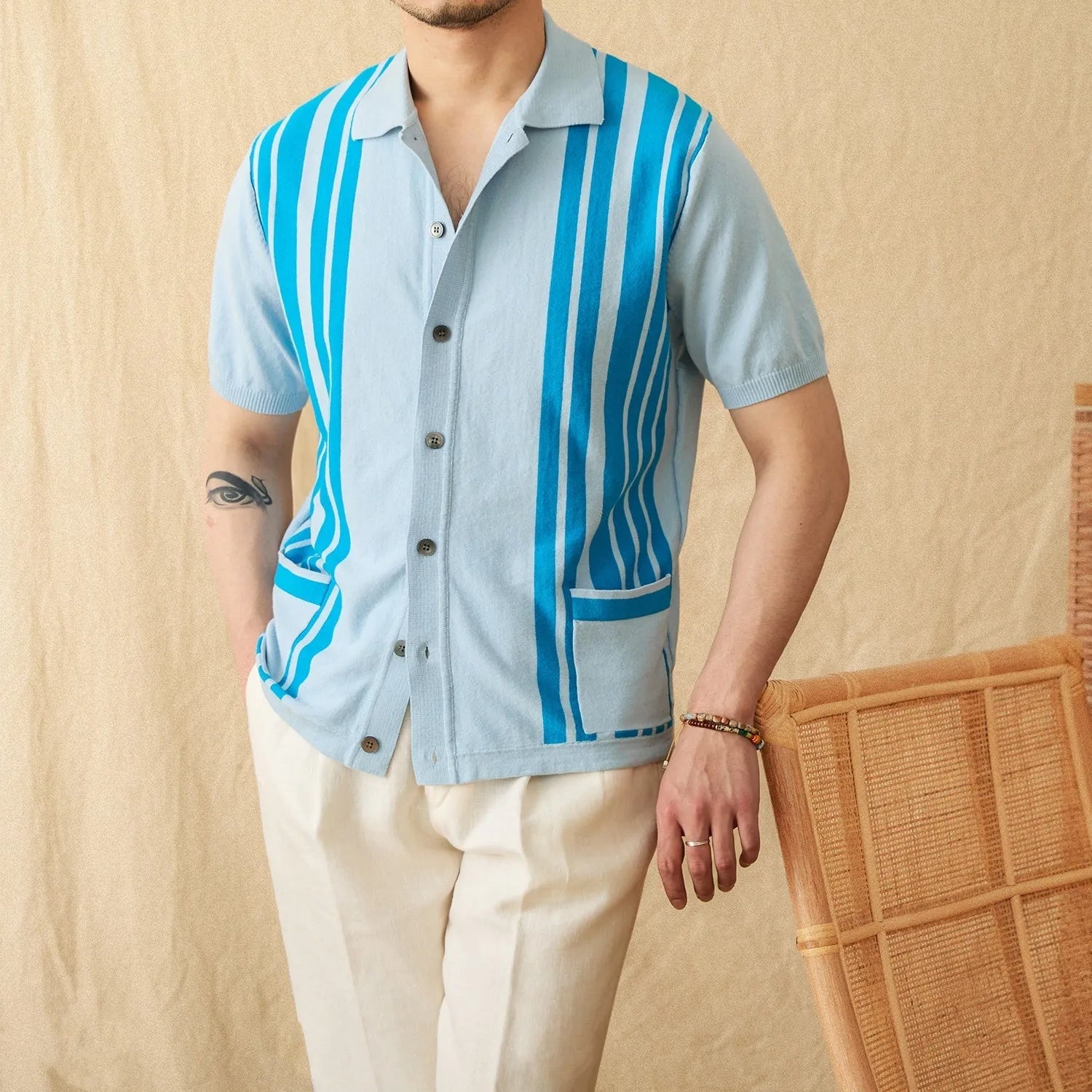 Cotton striped short sleeve knitted cardigan polo shirt on a hanger showing lapel collar.